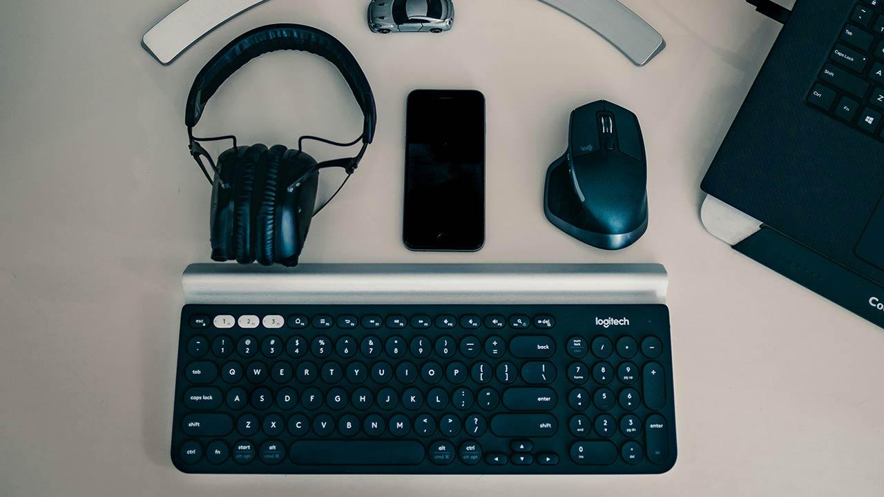 Mouse, keyboard, headphones and monitor on a table